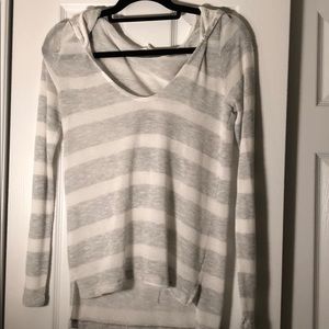 See-through high-low long sleeve shirt with hood.